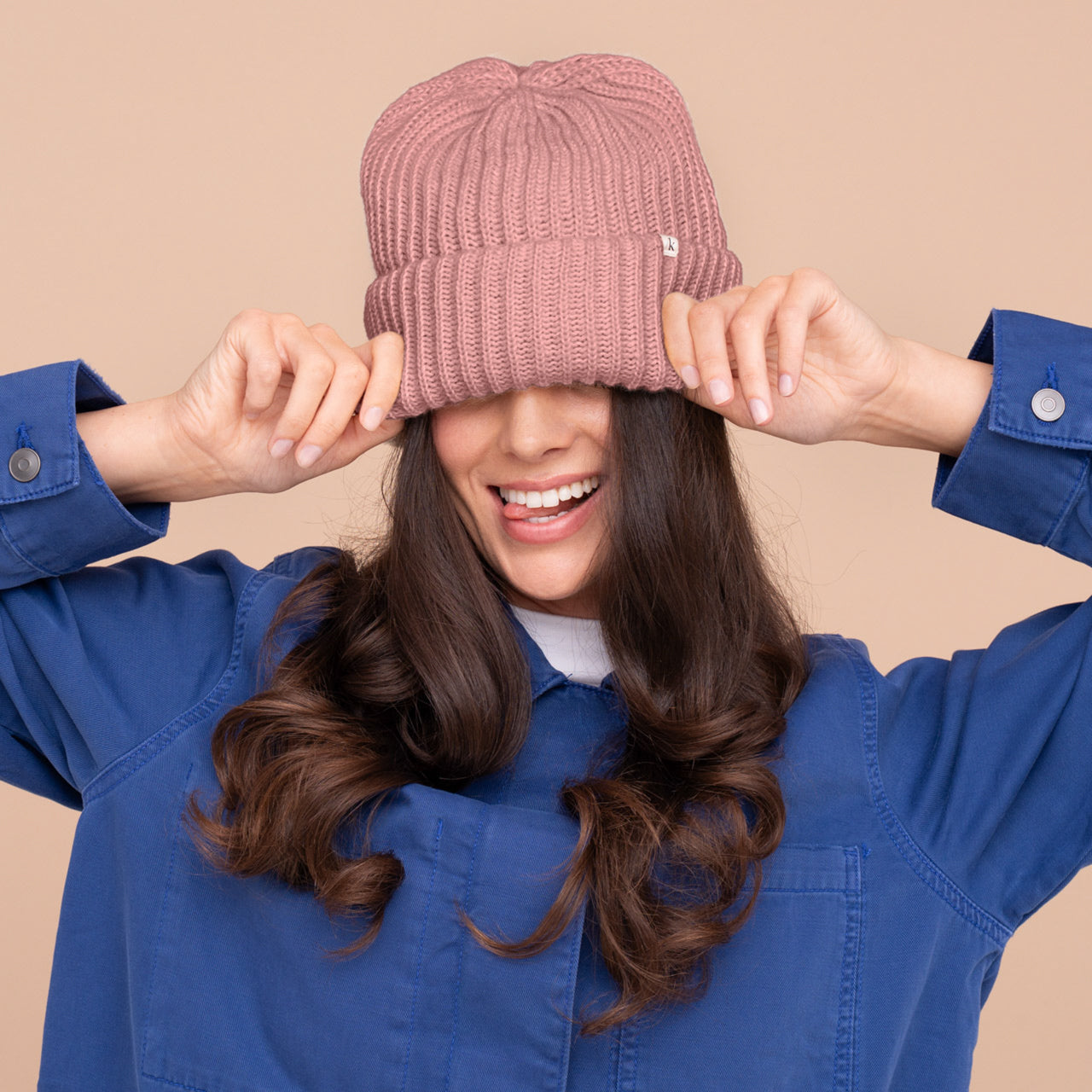 Model styling the Kitsch Glazey Satin-Lined Beanie in blush — lifestyle close-up