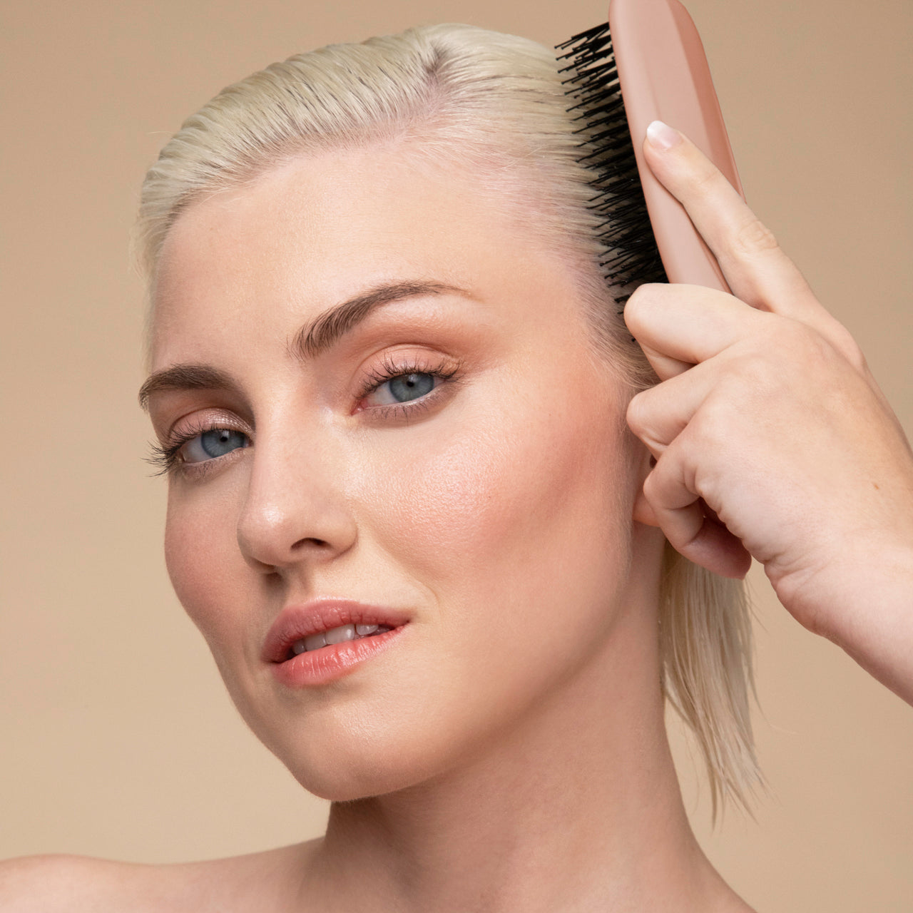 Model using the KITSCH Scalp Renewal Brush in Terracotta in the shower to massage shampoo into scalp — stimulates circulation and lather — part of the Bye Buildup Trio
