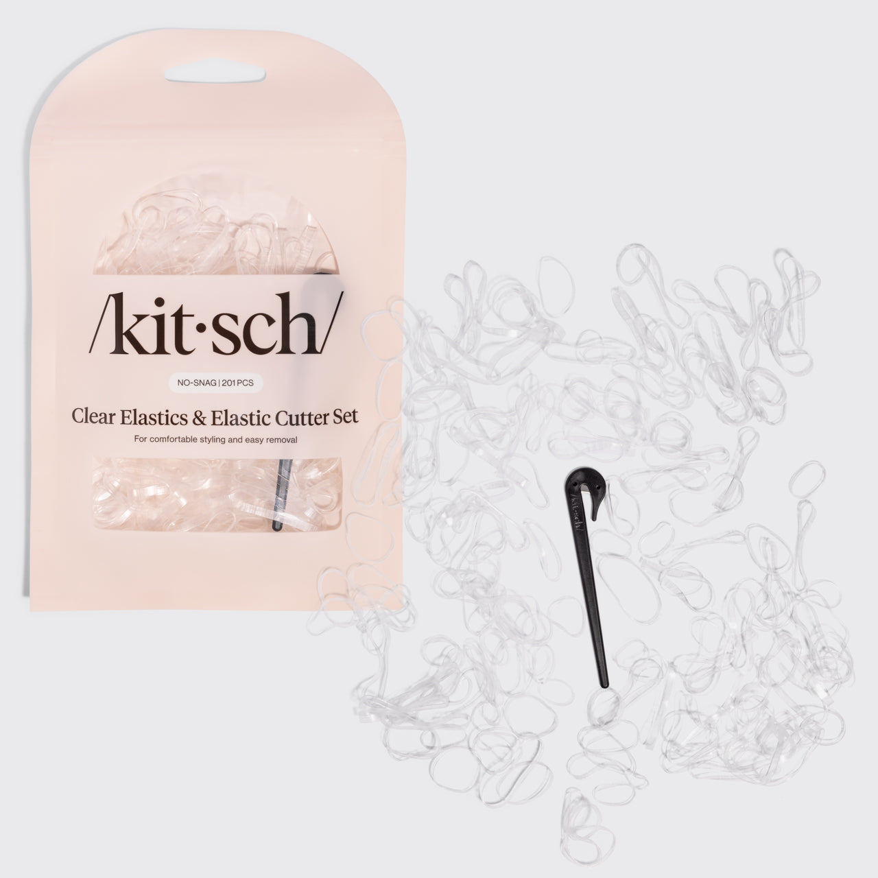 KITSCH No-Snag Elastics 200pcs & Recycled Plastic Elastic Cutter Set — hero shot of the clear no-snag elastics with the black elastic cutter — 200 damage-free elastics in three sizes plus a reusable cutter — gentle hold that won't snag or crease hair