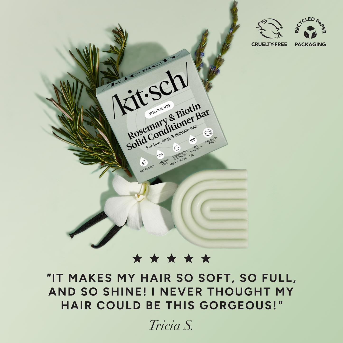 5-star customer review flat-lay for KITSCH Volumizing Rosemary & Biotin Solid Conditioner Bar on sage green background styled with rosemary sprigs, white flower, and vanilla beans — Tricia S.: "IT MAKES MY HAIR SO SOFT, SO FULL, AND SO SHINE! I NEVER THOUGHT MY HAIR COULD BE THIS GORGEOUS!" — Cruelty-Free, Recycled Paper Packaging